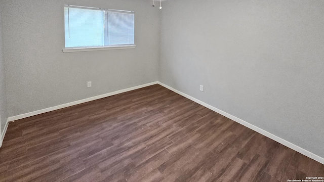 spare room featuring dark hardwood / wood-style floors