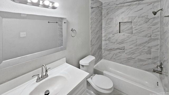 full bathroom with toilet, vanity, and tiled shower / bath