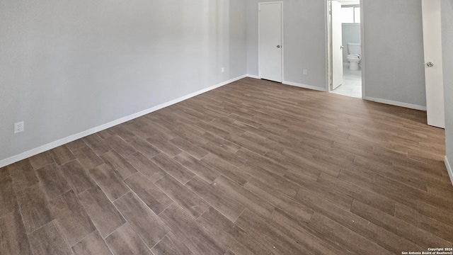 empty room with dark wood-type flooring