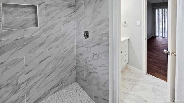 bathroom featuring vanity and a tile shower