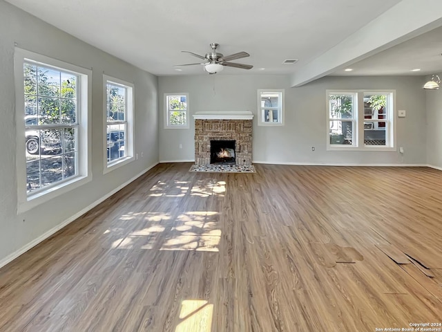 unfurnished living room with hardwood / wood-style floors and a healthy amount of sunlight