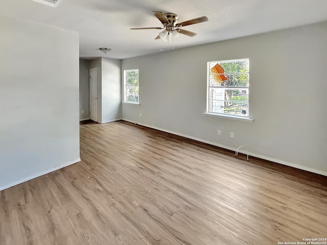 unfurnished room with ceiling fan and light hardwood / wood-style floors