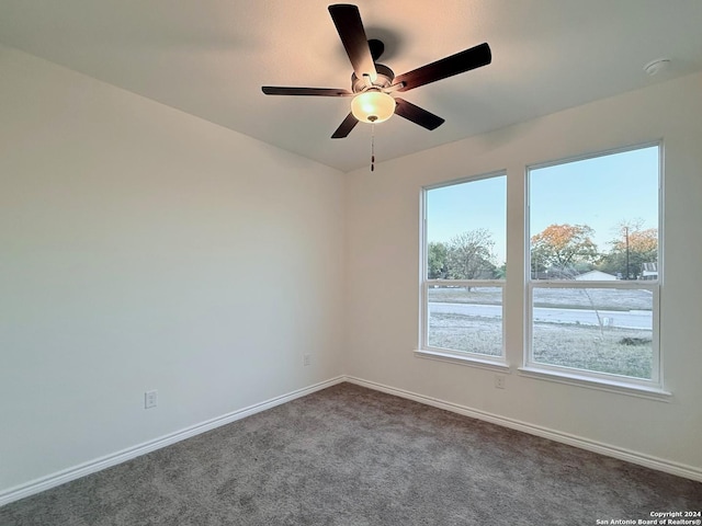 carpeted spare room with ceiling fan