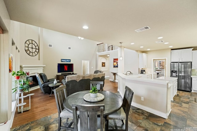 dining room with dark hardwood / wood-style floors and sink