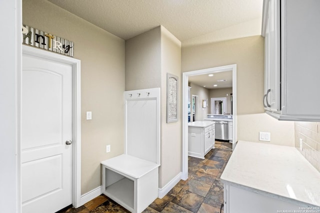 mudroom with a textured ceiling