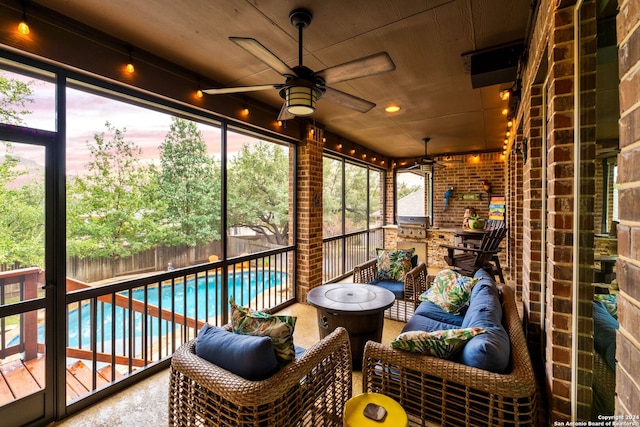 unfurnished sunroom with ceiling fan