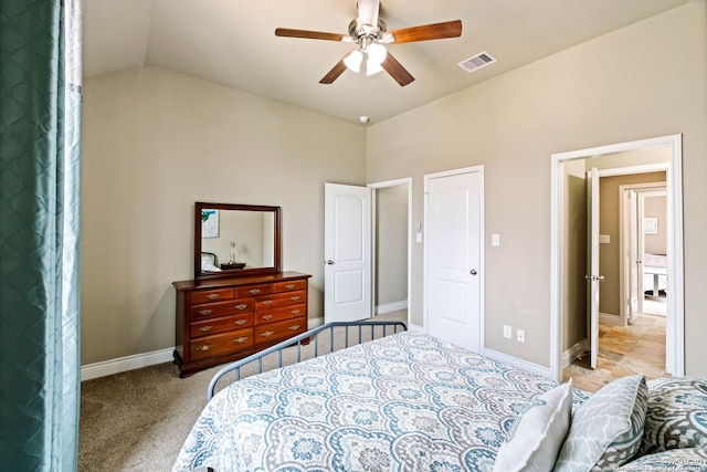 bedroom featuring ceiling fan, light carpet, and vaulted ceiling