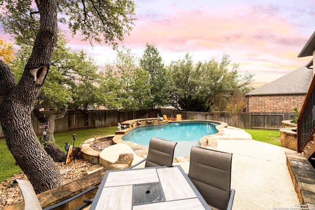 pool at dusk with a patio