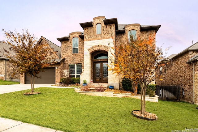 view of front of property with a lawn and french doors