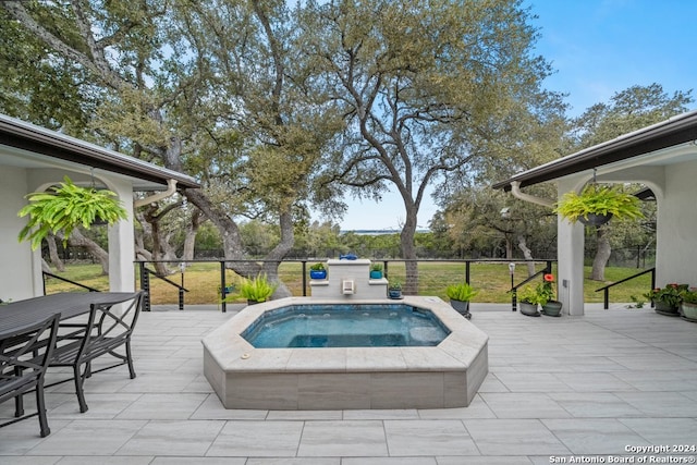 view of pool with an in ground hot tub and a patio