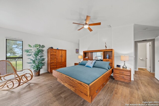 bedroom featuring hardwood / wood-style flooring, ceiling fan, and lofted ceiling
