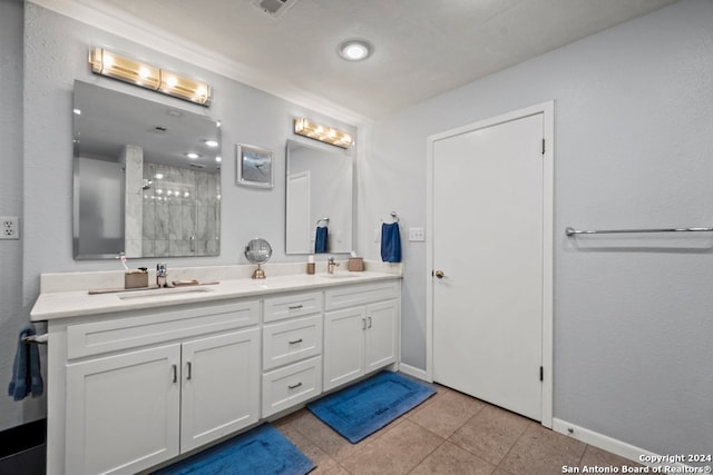 bathroom featuring tile patterned floors, vanity, an enclosed shower, and a textured ceiling