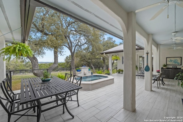 view of patio / terrace featuring an in ground hot tub and ceiling fan