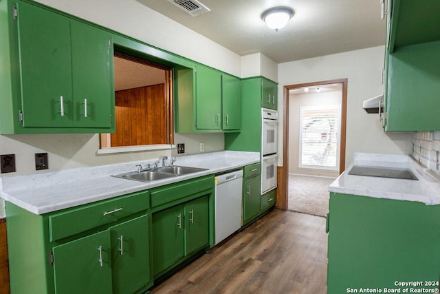 kitchen featuring white appliances, ventilation hood, sink, green cabinetry, and dark hardwood / wood-style floors