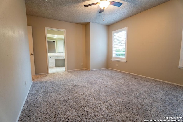 carpeted empty room featuring a textured ceiling and ceiling fan