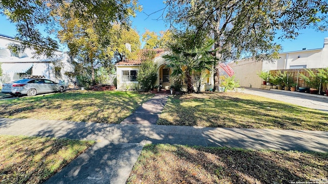 mediterranean / spanish-style home with a front lawn