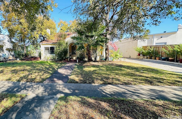 mediterranean / spanish house featuring a front lawn