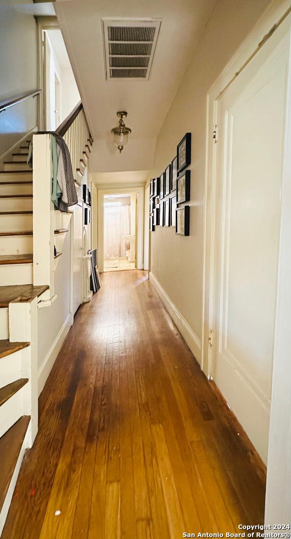 hall with hardwood / wood-style floors