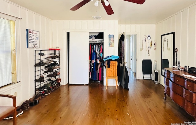 bedroom featuring ceiling fan, dark hardwood / wood-style flooring, and a closet