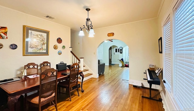 office featuring hardwood / wood-style floors, an inviting chandelier, and ornamental molding