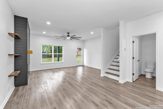 unfurnished living room with ceiling fan and light wood-type flooring