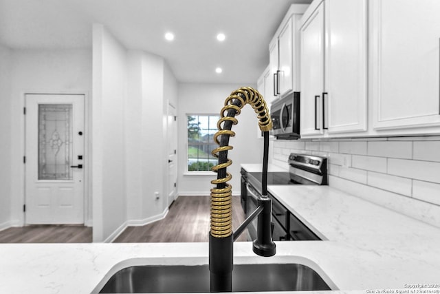 kitchen featuring light stone countertops, white cabinets, and appliances with stainless steel finishes