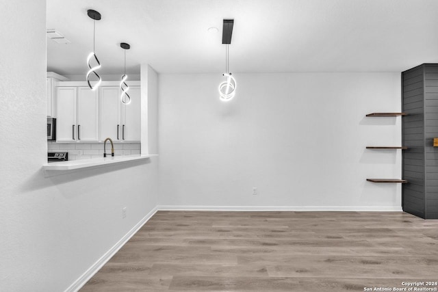 unfurnished dining area with light hardwood / wood-style flooring and sink