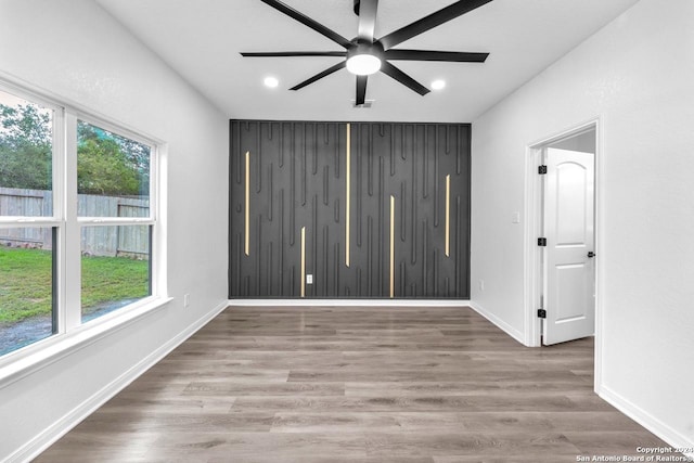 unfurnished room with wood-type flooring and ceiling fan