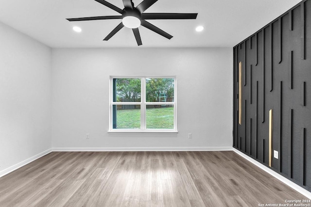 spare room with light hardwood / wood-style floors and ceiling fan