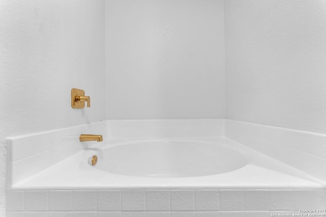 bathroom with tiled bath