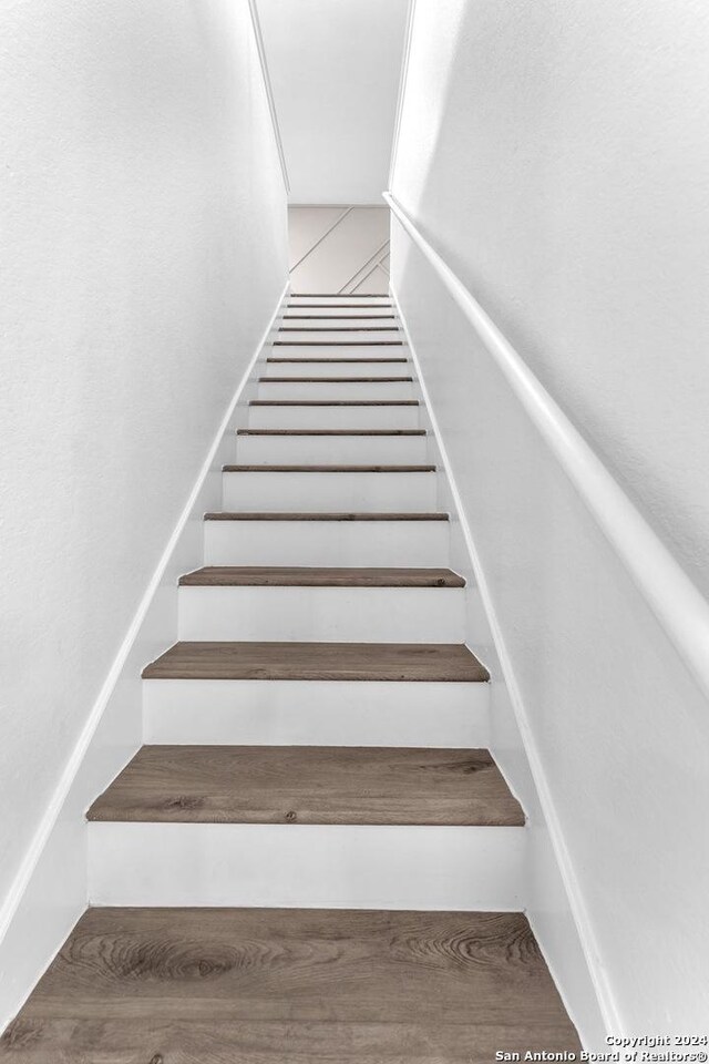 stairs featuring hardwood / wood-style flooring