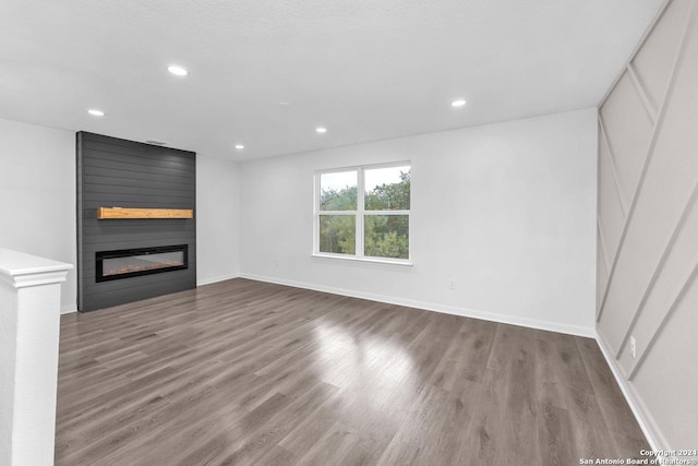 unfurnished living room with a fireplace and wood-type flooring