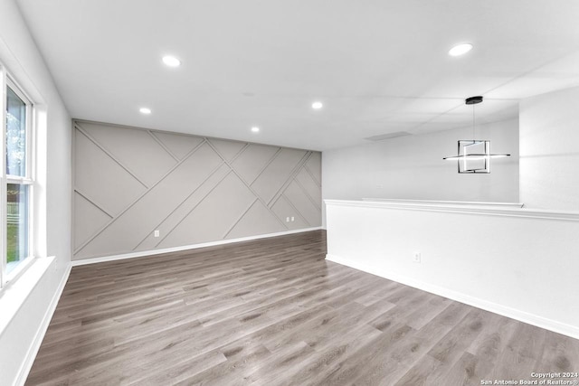 unfurnished room with hardwood / wood-style floors