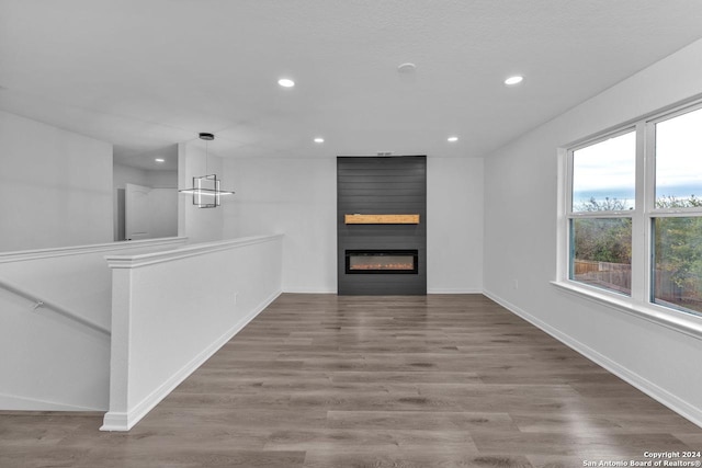 unfurnished living room featuring a fireplace and hardwood / wood-style flooring