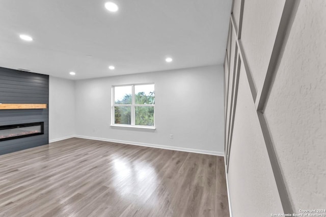 unfurnished living room featuring a fireplace and light wood-type flooring