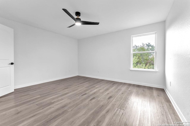 spare room featuring ceiling fan and wood-type flooring