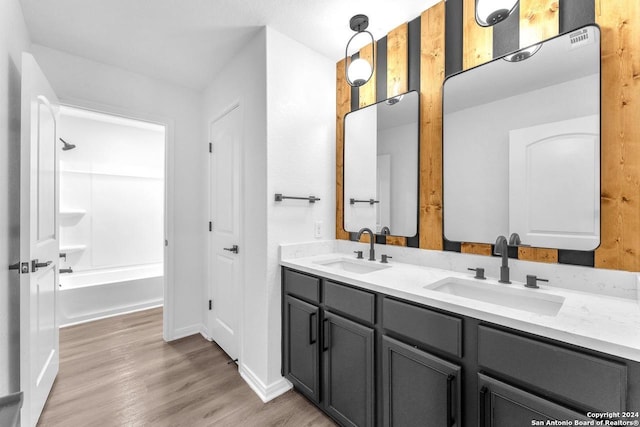 bathroom with shower / washtub combination, vanity, and hardwood / wood-style flooring