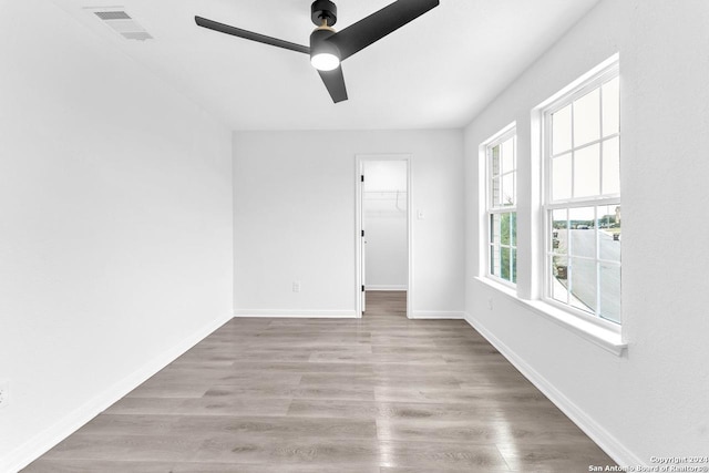 unfurnished room featuring ceiling fan and light wood-type flooring