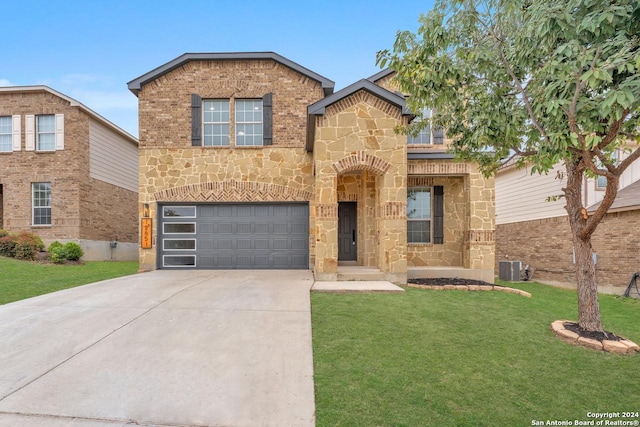 view of front of property featuring a front lawn, a garage, and central AC