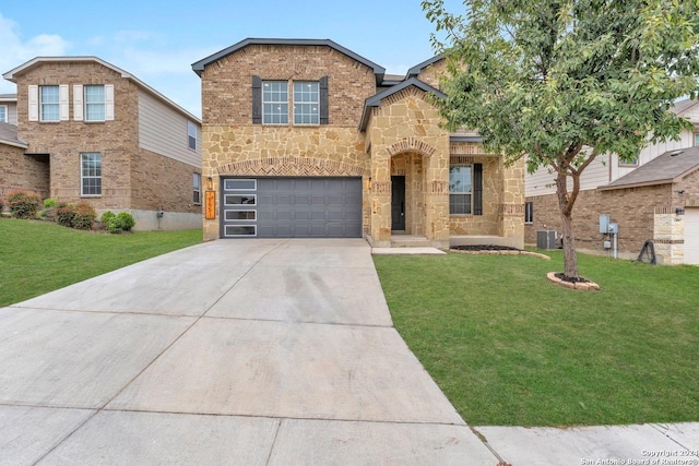 view of front of property with a front lawn, a garage, and central AC