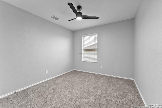 carpeted spare room with ceiling fan