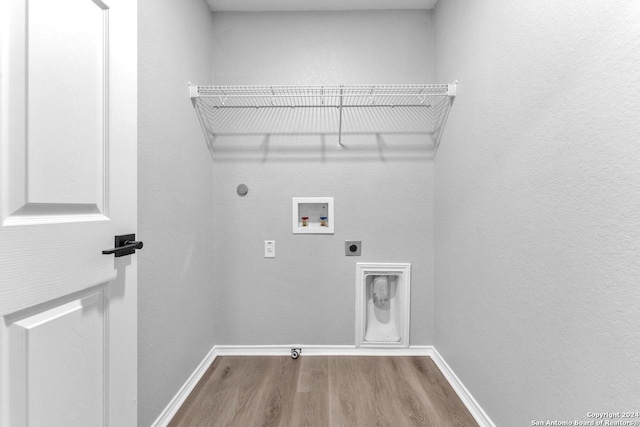 laundry room featuring hookup for an electric dryer, hookup for a gas dryer, hardwood / wood-style flooring, and washer hookup