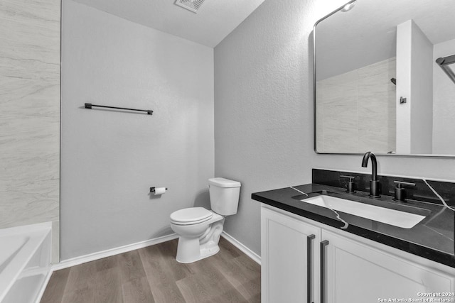 full bathroom featuring shower / bathing tub combination, toilet, vanity, and hardwood / wood-style flooring