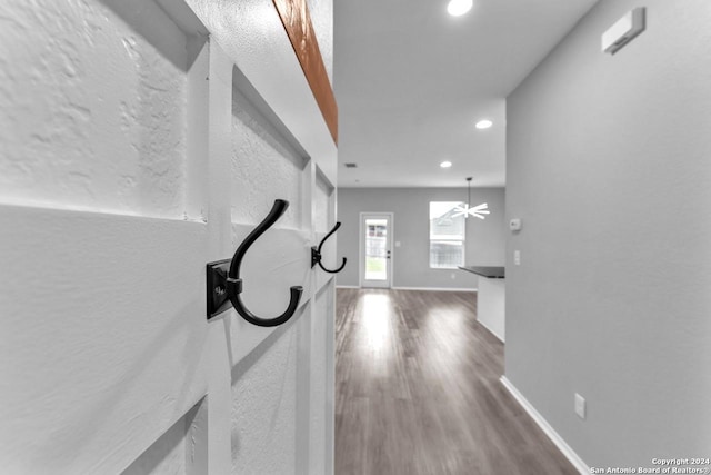 unfurnished living room featuring ceiling fan and hardwood / wood-style flooring