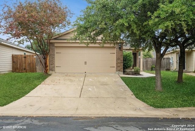 view of front of home with a front yard and a garage