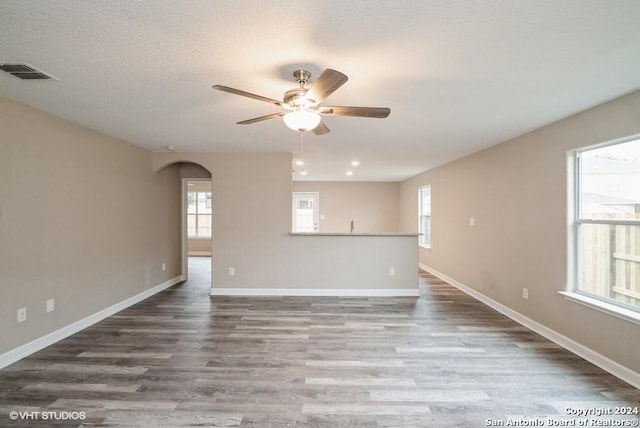 spare room featuring ceiling fan, hardwood / wood-style floors, and a textured ceiling