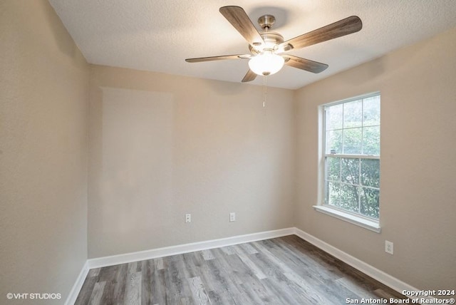 spare room with wood-type flooring, a textured ceiling, and ceiling fan