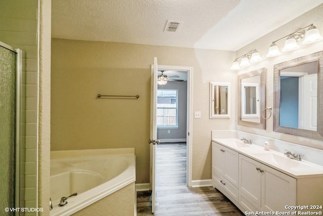 bathroom featuring vanity, a textured ceiling, ceiling fan, hardwood / wood-style flooring, and independent shower and bath