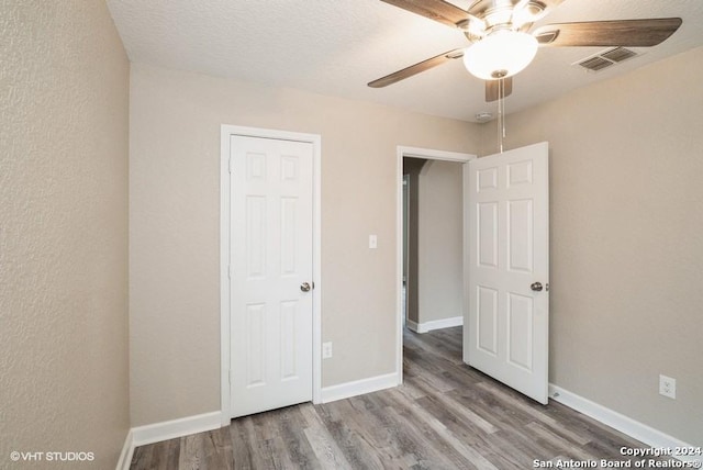 unfurnished bedroom with hardwood / wood-style flooring and ceiling fan