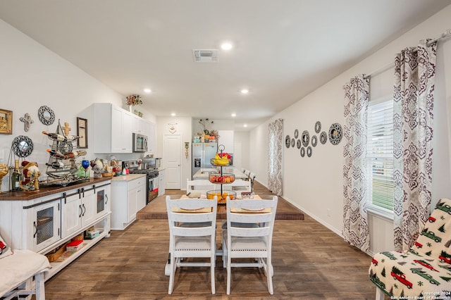 dining area with dark hardwood / wood-style floors